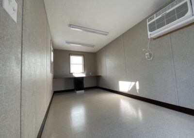 large room with desk, air conditioning unit