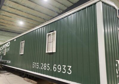 exterior of green mobile office, white trim