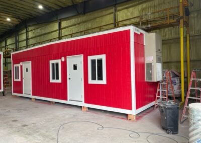 exterior view of red structure with white trim